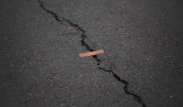 broken asphalt with bandaid